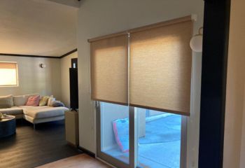 Campbell living room featuring custom roller sheer shades installed on a large patio sliding glass door, allowing filtered sunlight and elegant privacy.