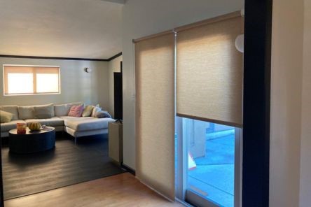 Close-up view of sheer pull down window shades on a Campbell patio sliding glass door, showcasing smooth operation and premium fabric.